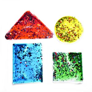 Formas geométricas de gelatina translúcidas para la mesa de luz con purpurina y con diferentes colores, rojo, verde, amarillo y azul