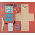 Caja y contenido de Cluck, cluck! The fox! versión mini, juego cooperativo