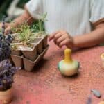 Tentetieso peonza pájaro Flowing yellow bird de Grapat en una mesa de jardín con plantas
