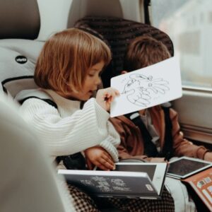 dos niños entretenidos en un viaje mientras juegan sin pantallas
