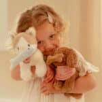 imagen de una niña con el perrito y el gatito de peluche
