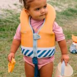imagen de una niña con el Chaleco flotador aprendizaje Rallas Azules talla 1/2