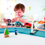 Imagen de un niño jugando con Tren transportador de coches de carreras de Hape
